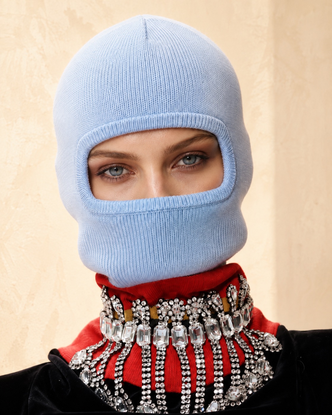 Model in a pale blue balaclava with a jewelled collar