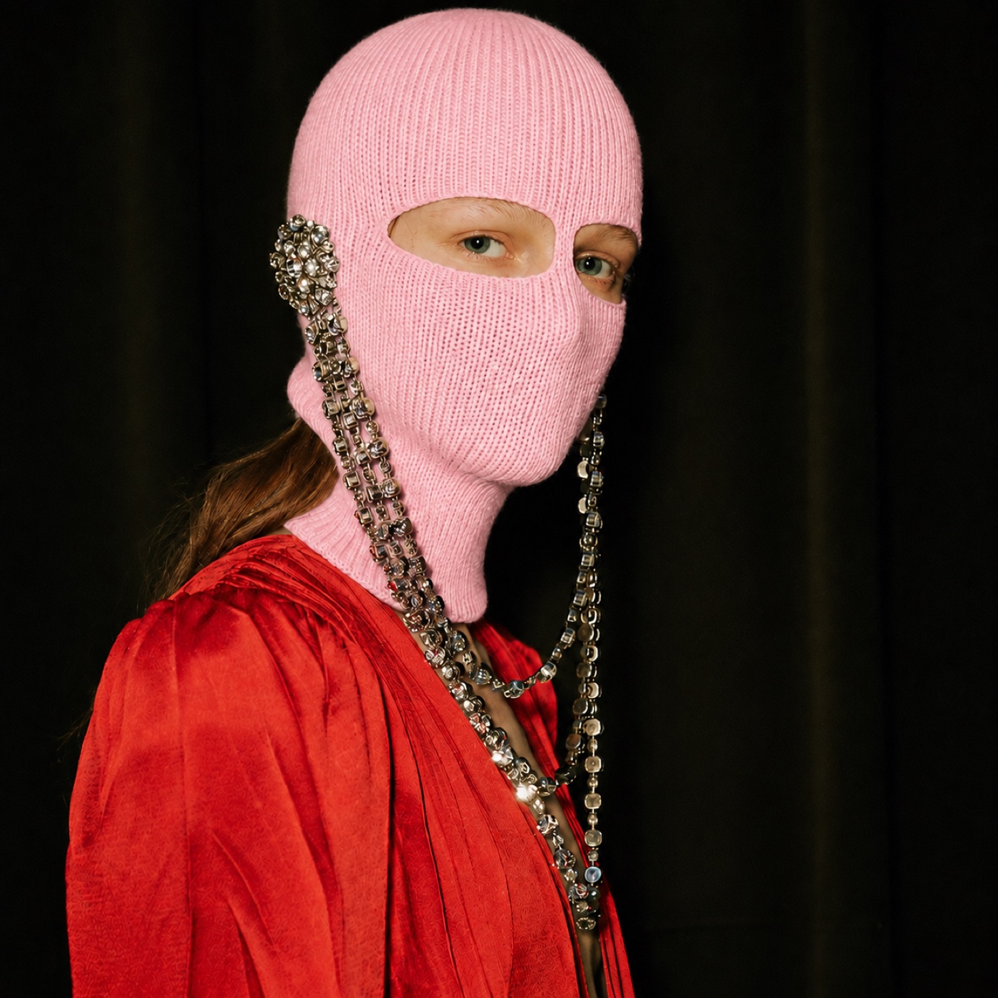 Model in a pink balaclava with jewelled chains